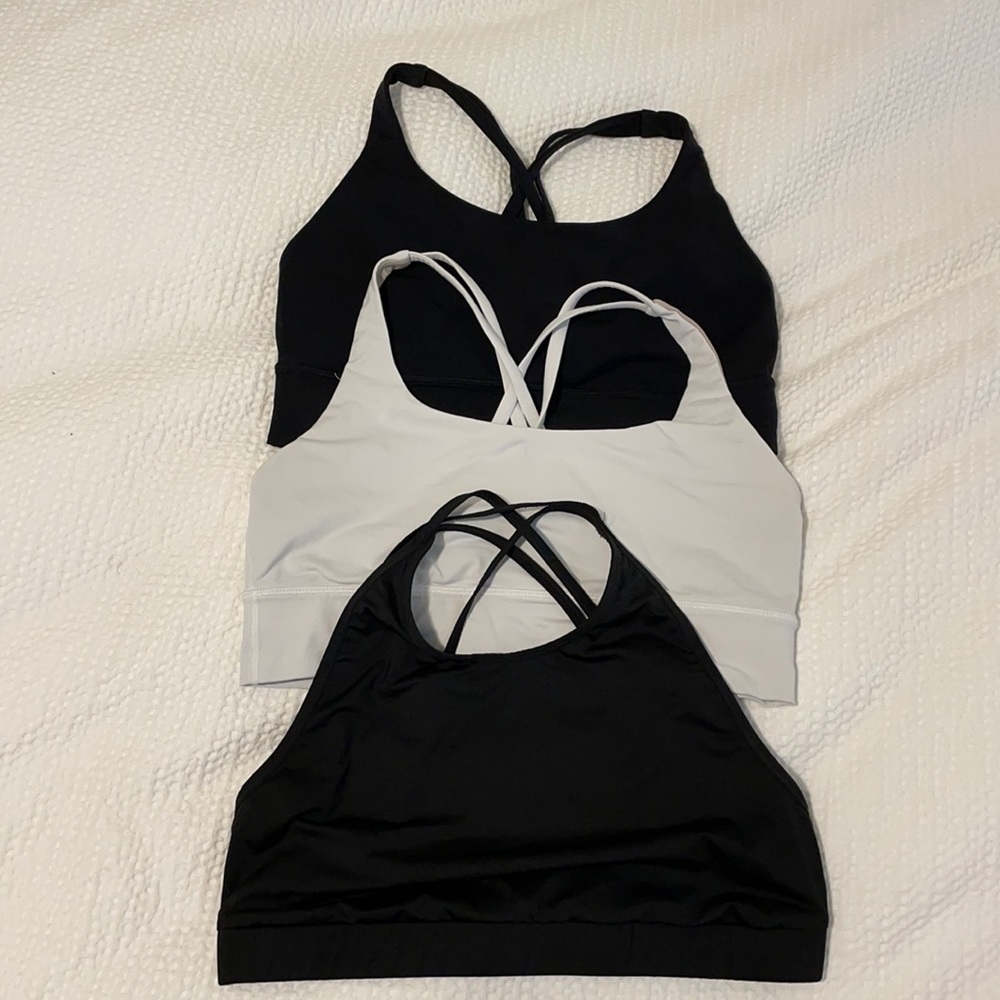 Three strappy sports bras, lululemon and alo yoga